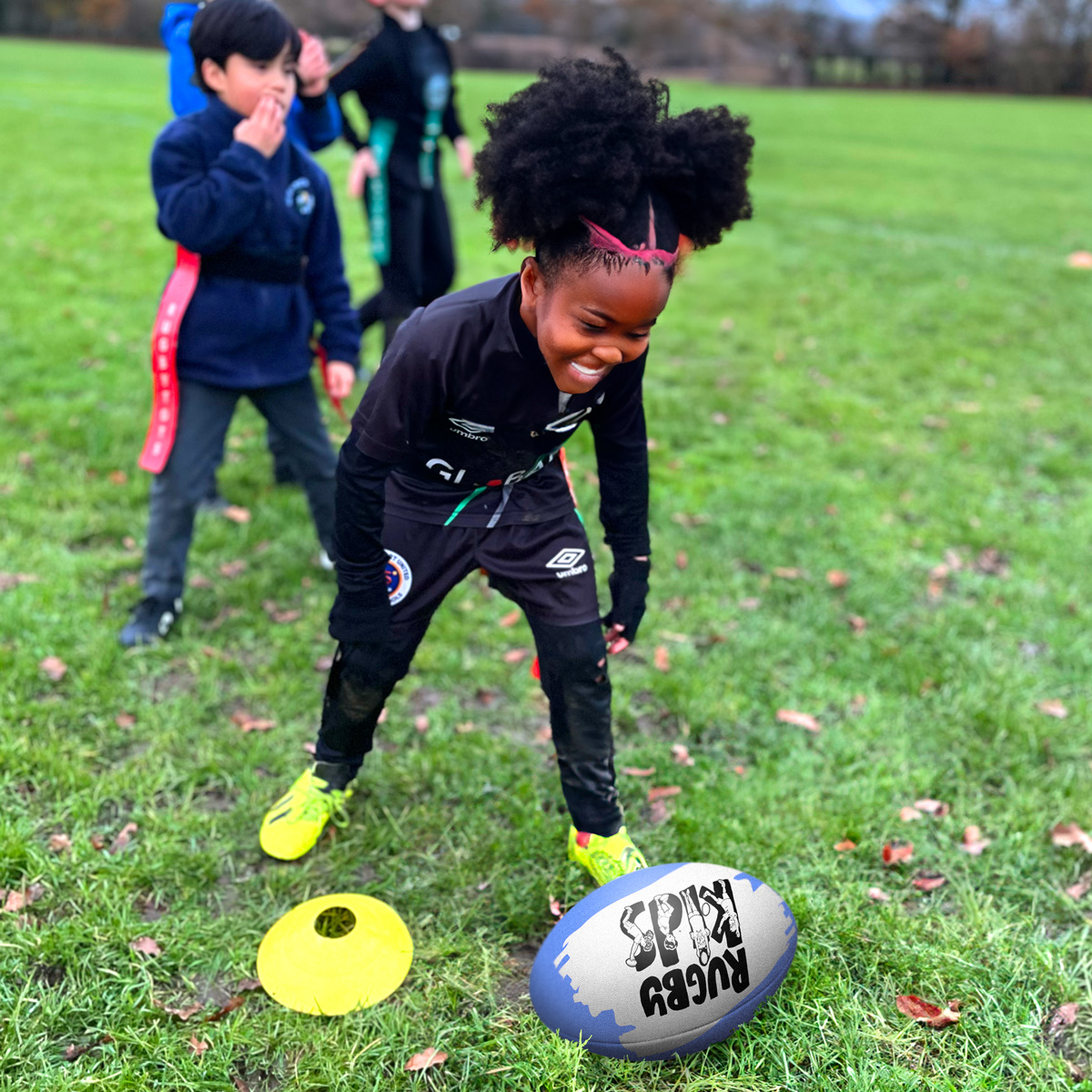 Girl with a rugby ball in a RugbyKids after-school club