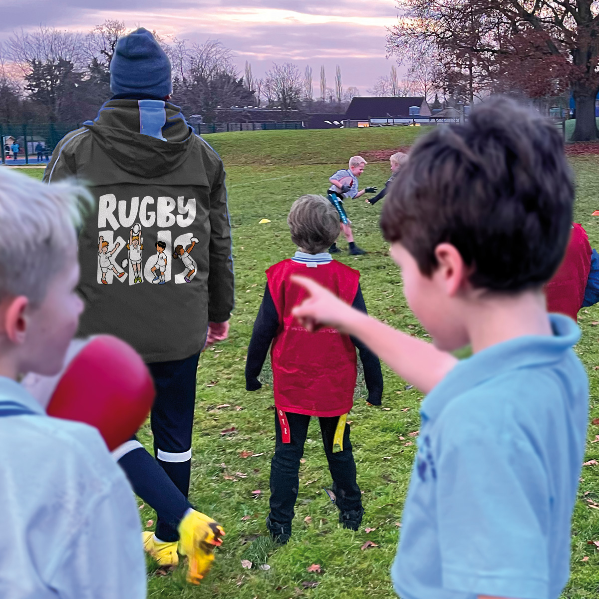 Schoolchildren learning rugby skills in a RugbyKids curriculum lesson